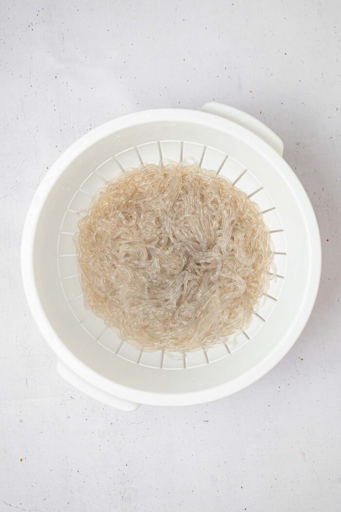 Glass noodles after being soaked in warm water and drained.