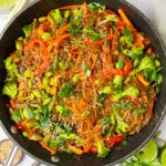 A pan containing glass noodle stir fry, ready to serve.