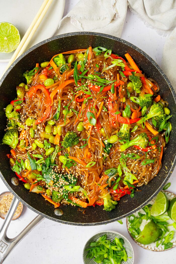A pan containing glass noodle stir fry, ready to serve.