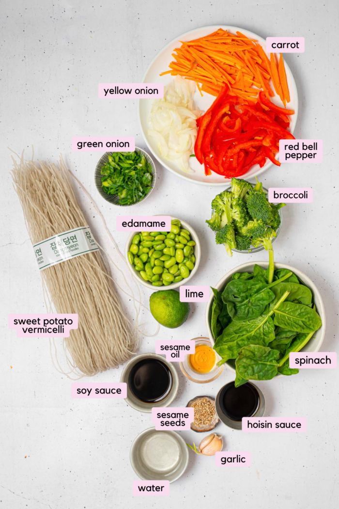 The ingredients for glass noodle stir fry laid out and labeled on a white background.
