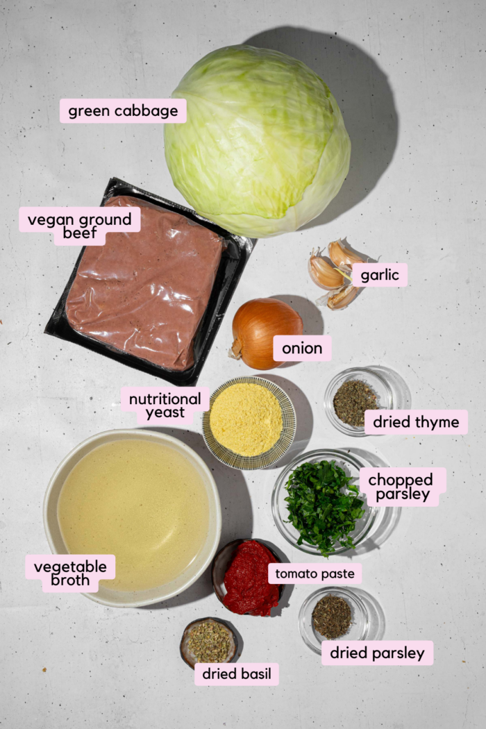 The ingredients for vegan cabbage rolls laid out and labeled on a clear white background.