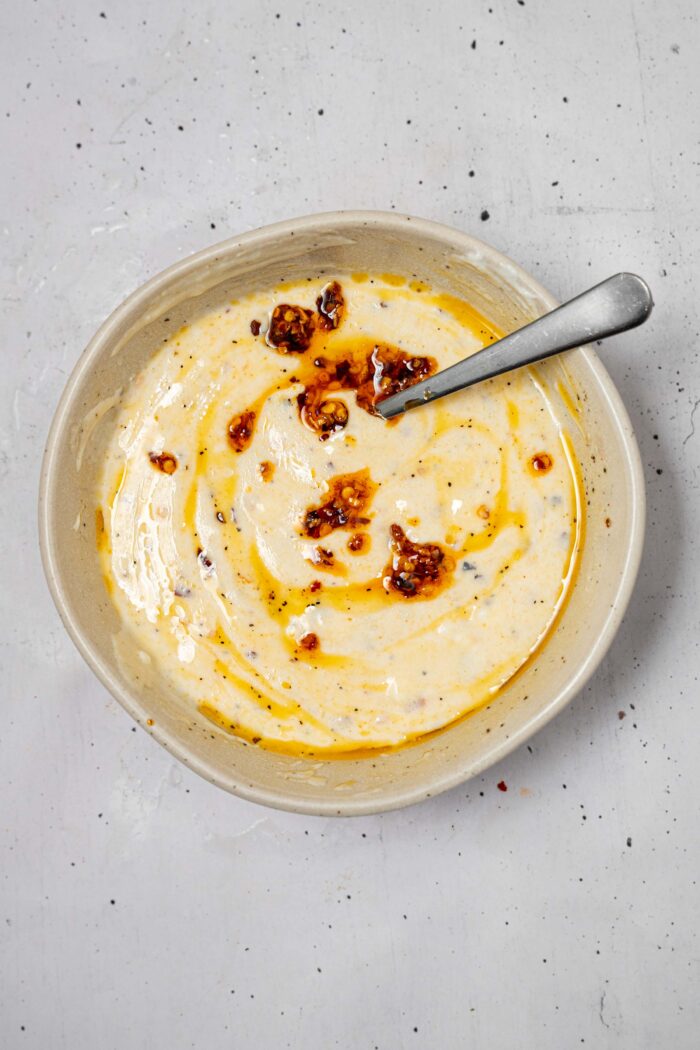 Spicy creamy dressing featuring vegan yogurt and chili crisp.