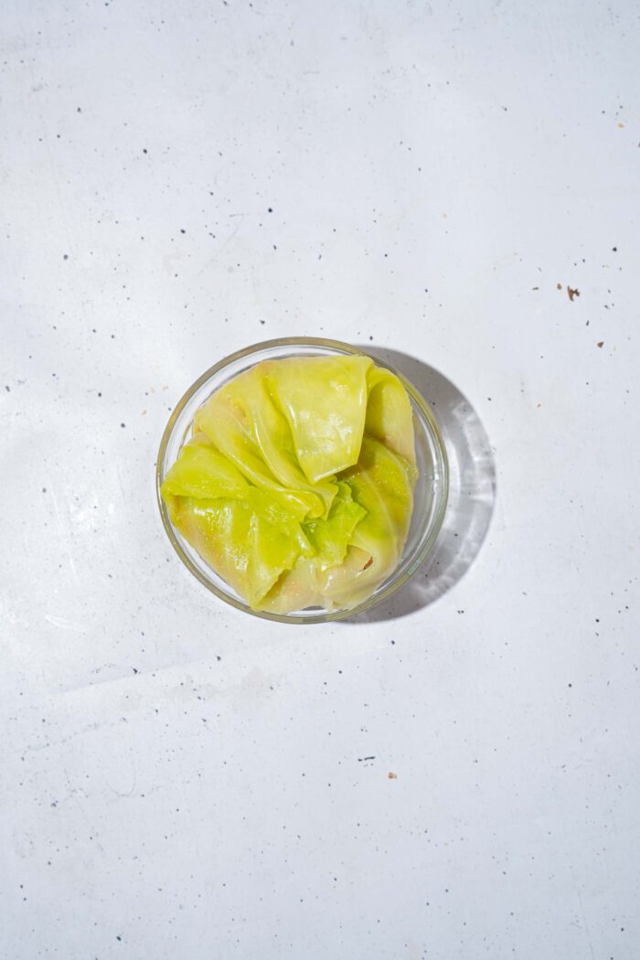 In a ramekin, the cabbage leaf is folded around the filling into a small "parcel".