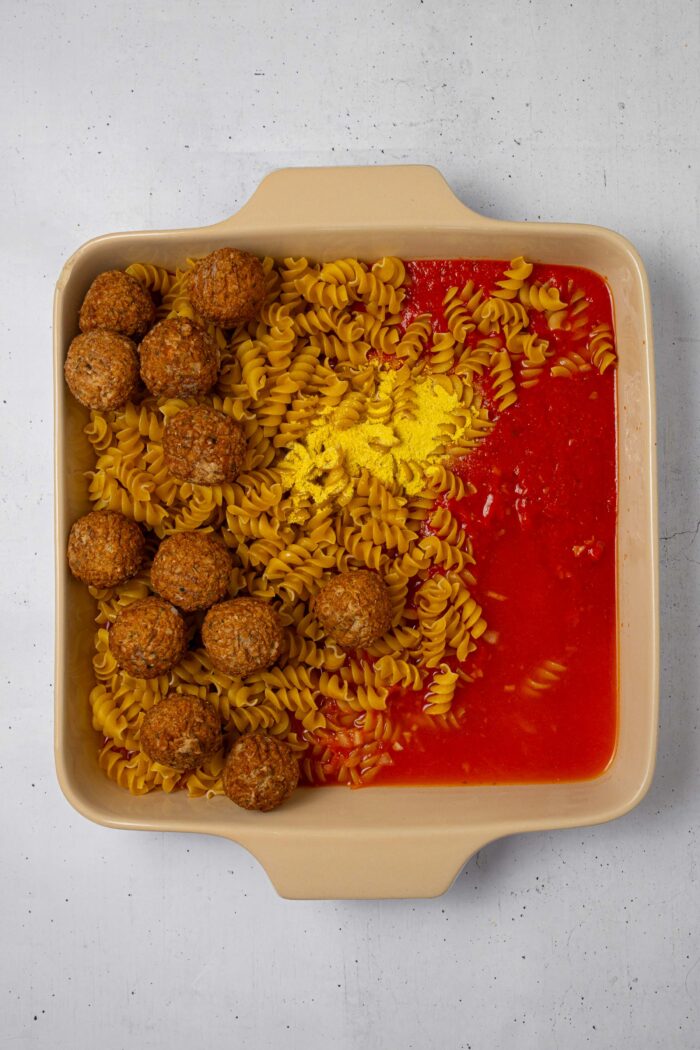 Dry pasta, tomato sauce, seasoning, and vegan meatballs, thrown all together in a casserole dish.