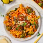 Top down view of vegan pasta and meatball bake served on a plate.