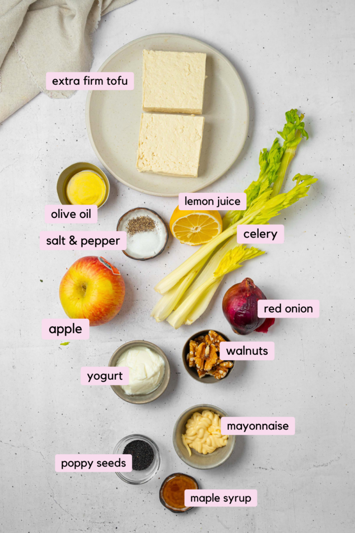 The ingredients for shredded tofu salad laid out and labeled on a clear white background.