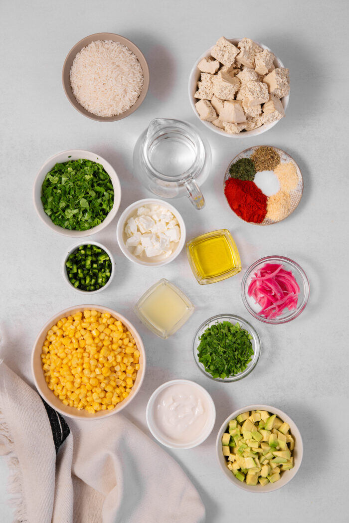 The ingredients required for street corn bowls laid out on a clear background.