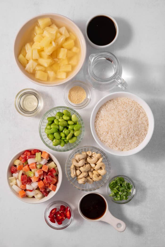 The ingredients for the pineapple rice, measured and laid out on a clear surface.