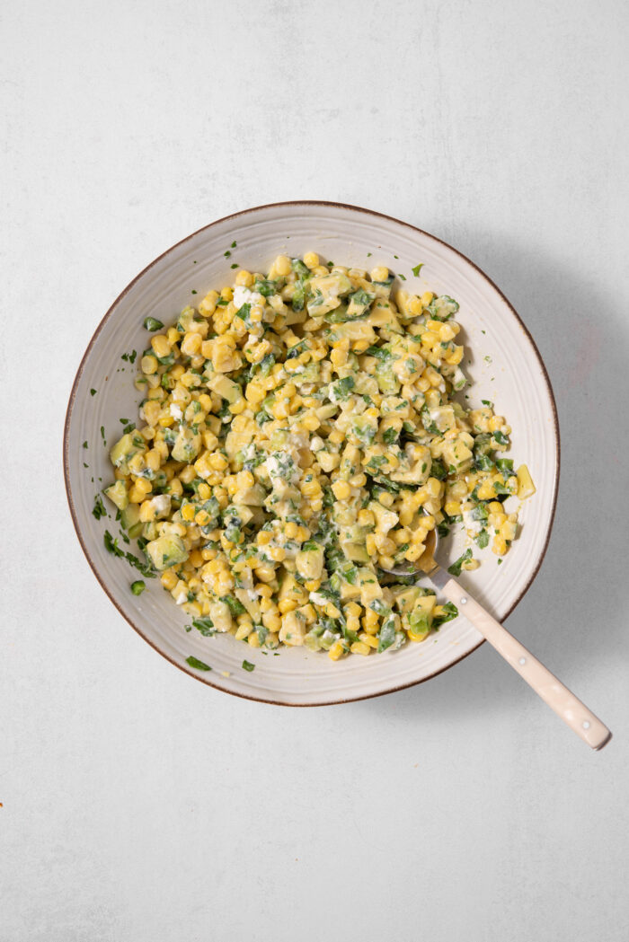 Mexican street corn mixed with a creamy dressing for a delicious vegan street corn salad.