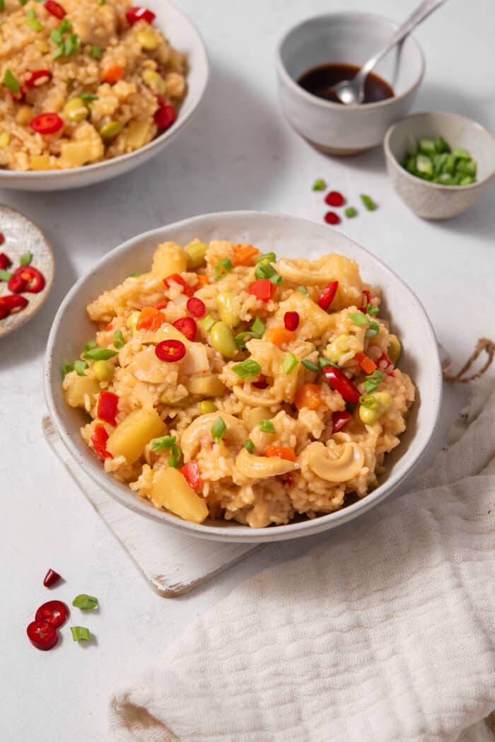 A bowl of pineapple rice served with green onions.