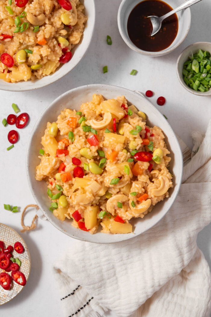 Top down view of the pineapple rice served in a bowl with some green onions.