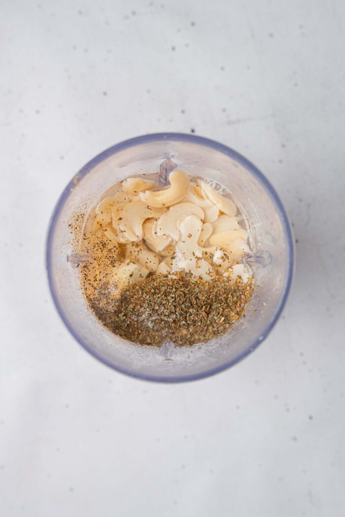 The vegan ranch ingredients added to a high-speed blender.