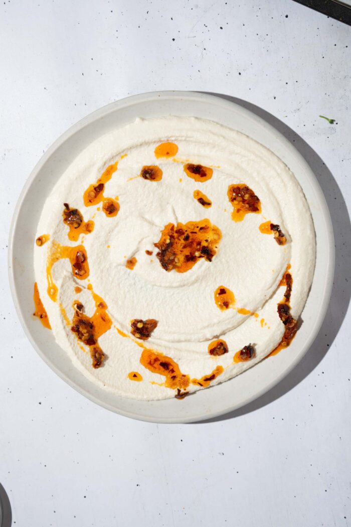 Chili oil drizzled over the whipped tofu sauce.