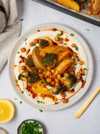 A serving of vegan sheet pan dinner with whipped tofu and chili oil.