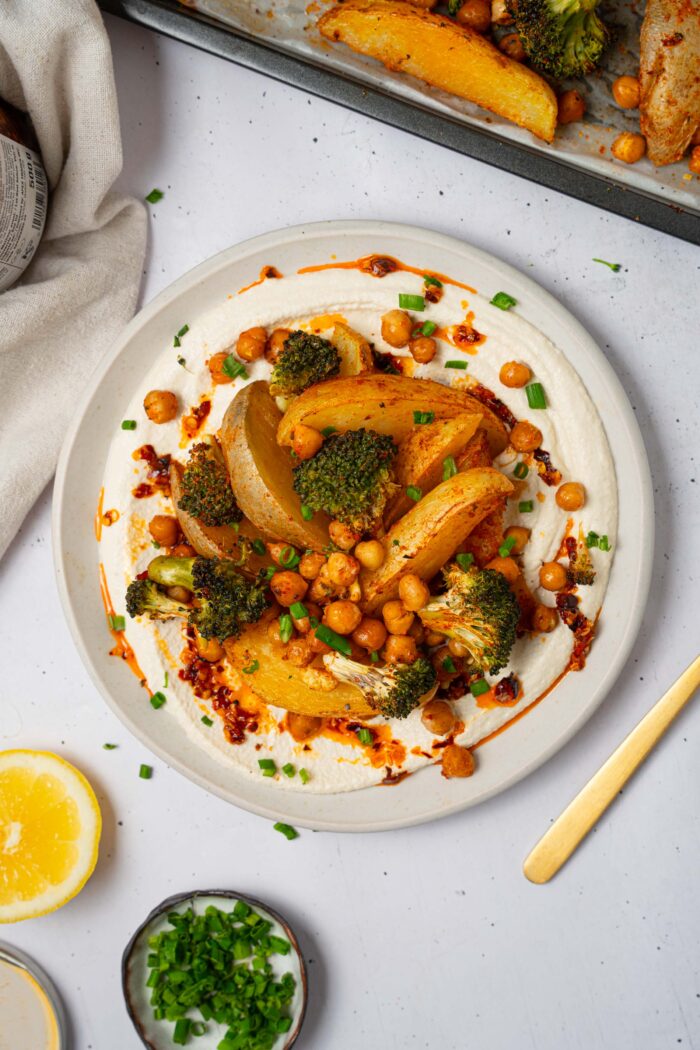 A serving of vegan sheet pan dinner with whipped tofu and chili oil.