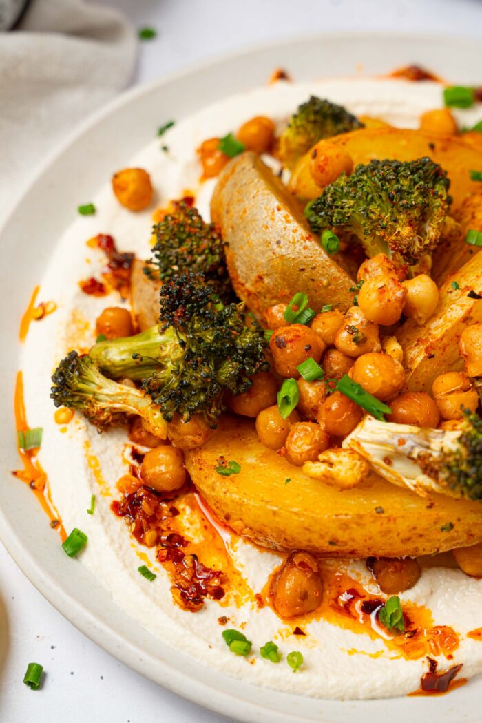 A close up of vegan sheet pan dinner served with whipped tofu.