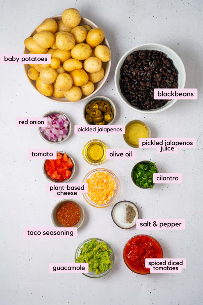 The ingredients for smashed potato nachos laid out and labeled on a clear white background.