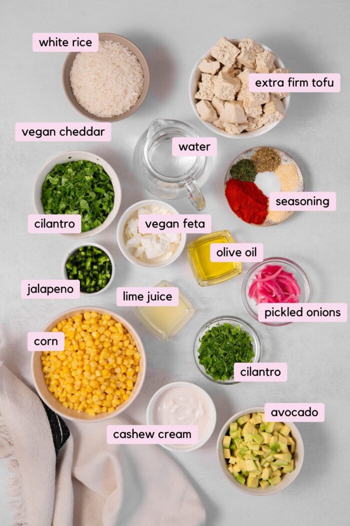 All the ingredients required to make street corn bowls laid out on a clear background.