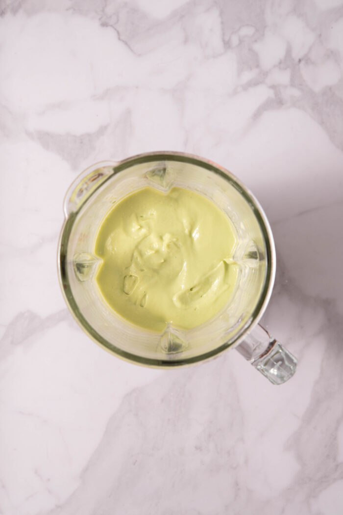 Creamy avocado pasta sauce in a blender.