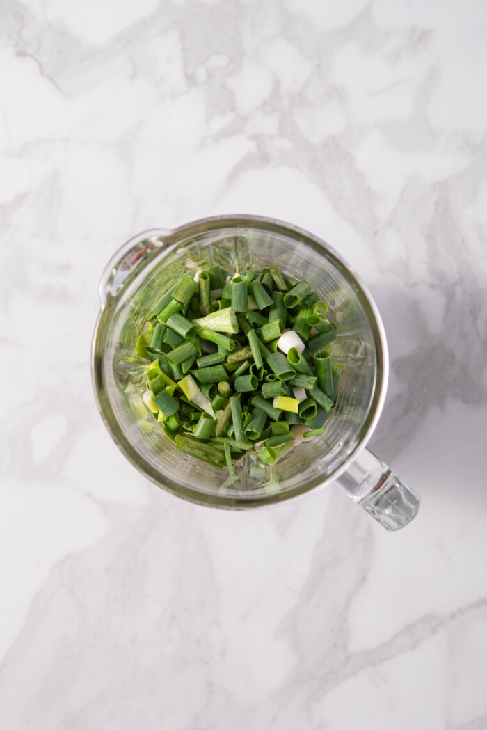 All the ingredients for the everything green sauce added to a high-speed blender.