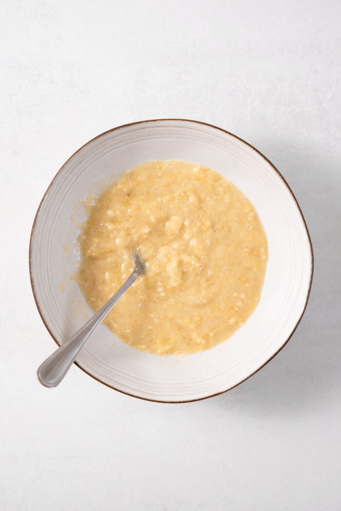 Mashed bananas in a mixing bowl.