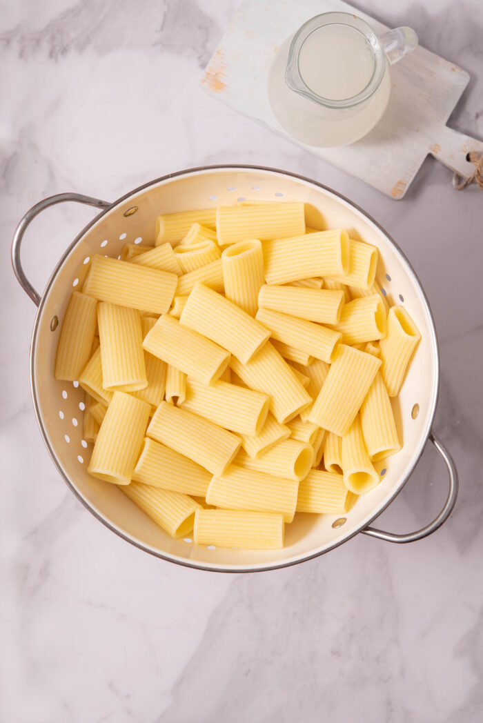Pasta, cooked and drained using a colander.