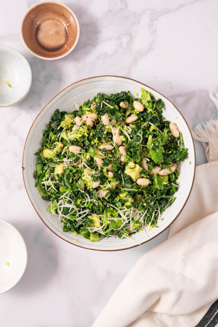 Kale mixed with other salad ingrediens, including bens, avocado and hemp hearts.
