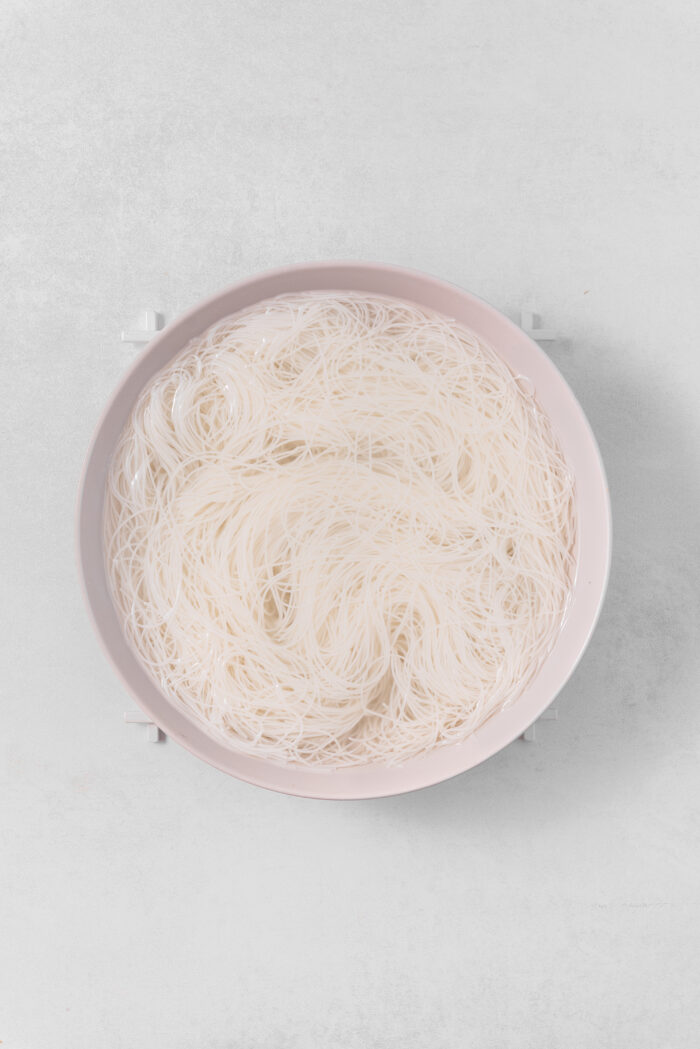 Vermicelli noodles soaked and drained, then placed in a shallow bowl.