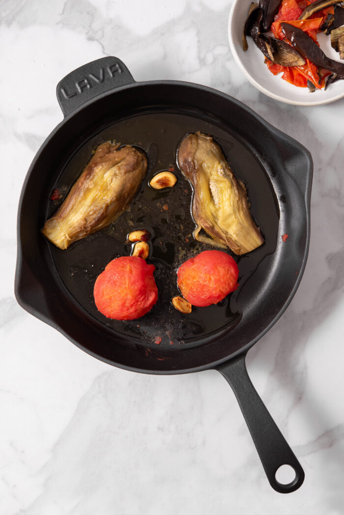 With the skin peeled off the eggplants and tomatoes, they are soft and ready to mash.