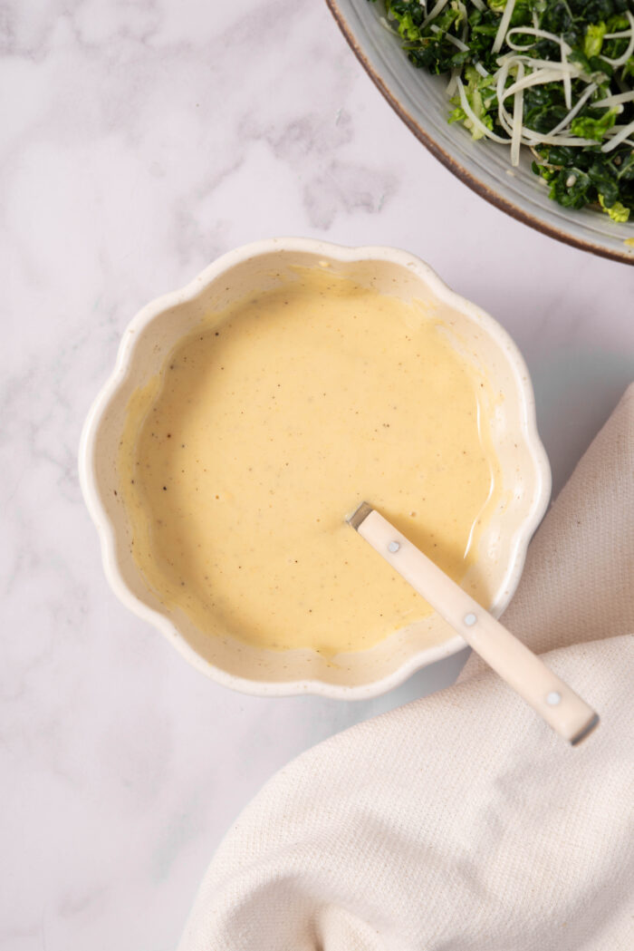 The dressing for the chopped kale salad mixed together in a small bowl.
