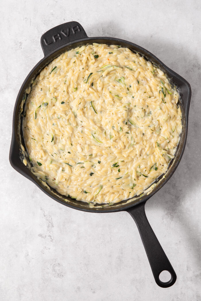 Orzo combined with coconut milk and vegetable broth, then left to cook all together.