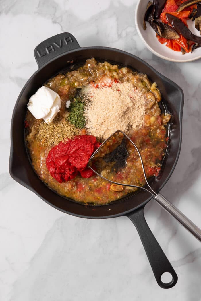 Tomato paste, vegan cream cheese, and spices added to the tomato and eggplant mixture.