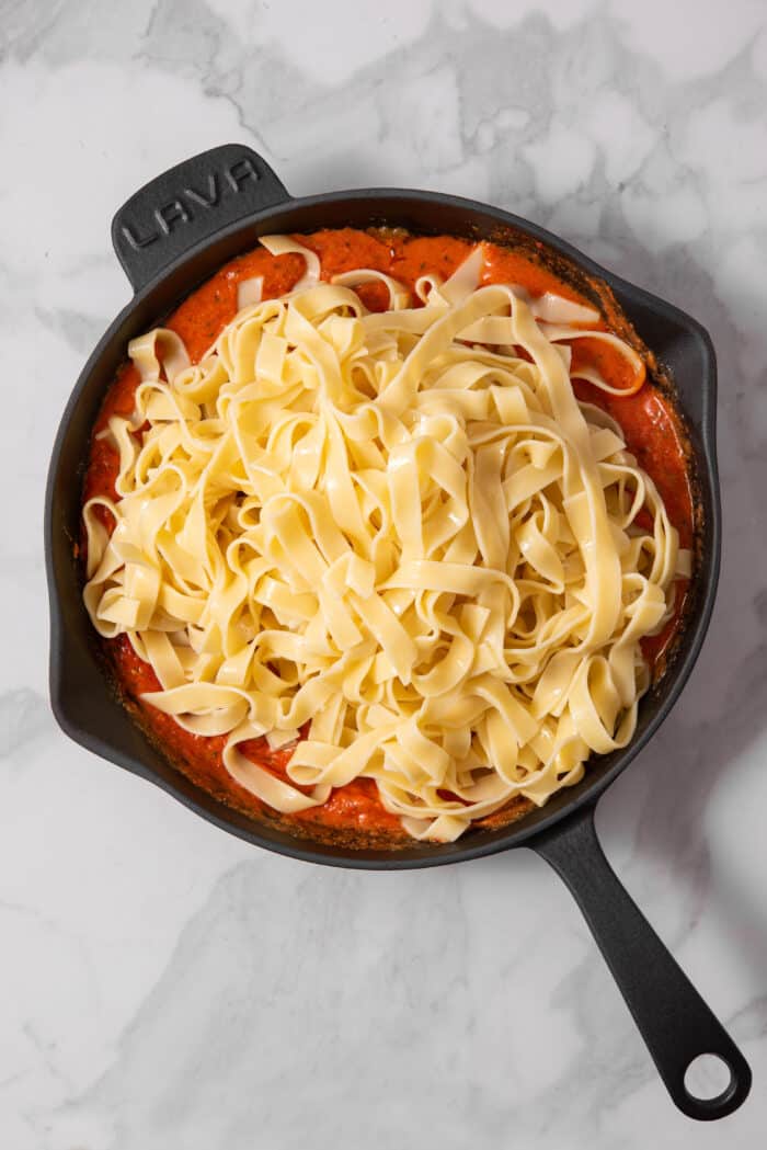 Pasta added to the skillet with creamy vegan eggplant sauce.