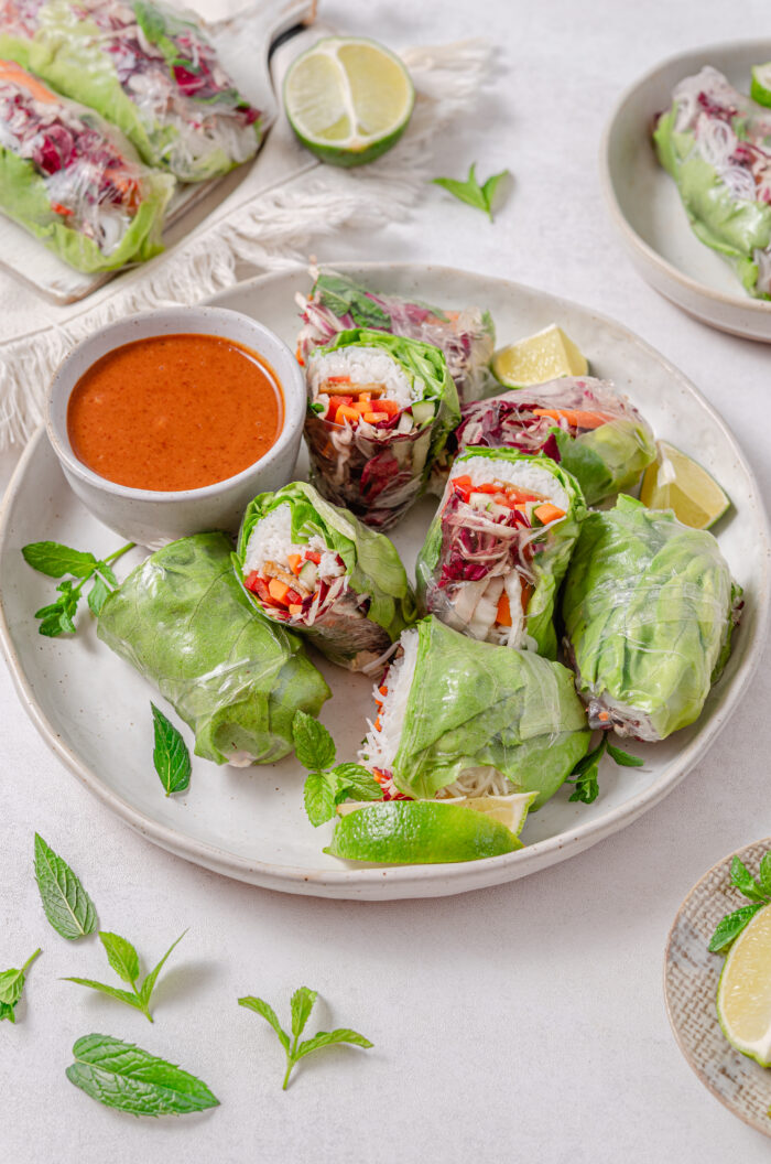 A platter of vegan summer rolls served with almond dipping sauce.