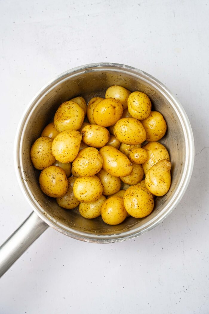 After cooking, the mini potatoes are drained.